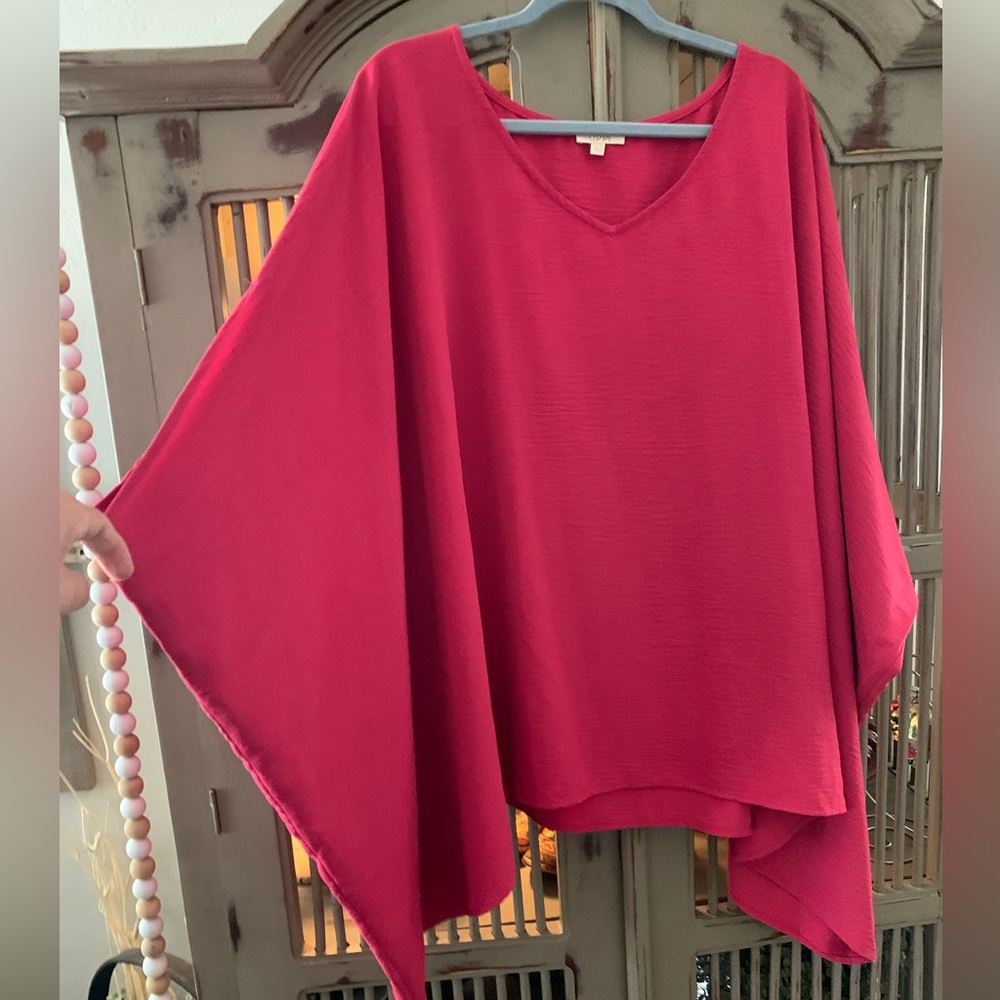 Poncho style shirt in a dark fuschia color